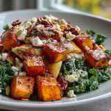 Fall Sweet Potato Harvest Bowl with sliced apples and crunchy toasted almonds, drizzled with tangy balsamic vinaigrette on a rustic table.