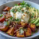 Golden roasted sweet potato cubes with crispy edges, creamy avocado, and cottage cheese in a Hot Honey Sweet Potato Bowl.