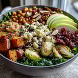 Savory Fall Harvest Bowl with roasted Brussels sprouts, crispy chickpeas, and a drizzle of tangy maple mustard dressing.