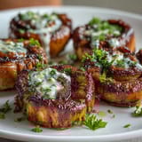 Golden-seared sea scallops bathed in rich lemon butter sauce, garnished with fresh parsley and lemon wedges.