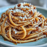 A close-up of Brown Butter Parmesan Pasta, steaming and generously topped with cheese.