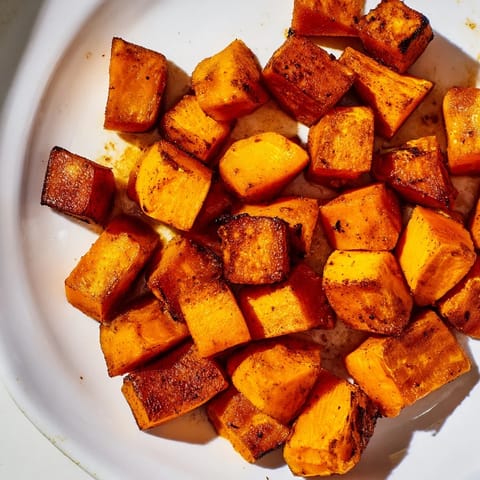 Vegan Roasted Sweet Potatoes served in a rustic white bowl, perfect for a healthy gluten-free side dish.