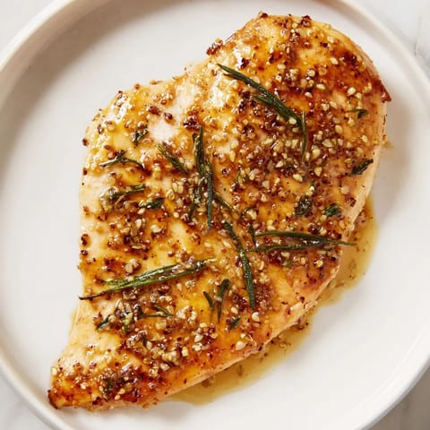 Savory Honey Dijon Chicken Skillet served over creamy mashed potatoes, garnished with fresh parsley for a comforting weeknight meal.