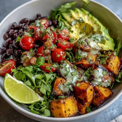 A vibrant Sweet Potato and Black Bean Bowl topped with creamy avocado, fresh salsa, and chopped cilantro.