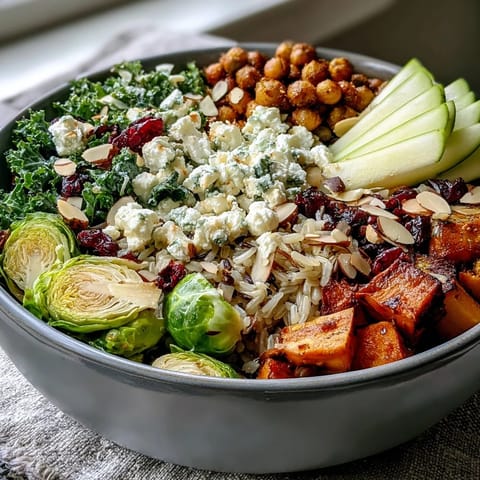 Fall Harvest Bowl with kale, wild rice, and roasted sweet potatoes, topped with crumbled feta and toasted almonds.