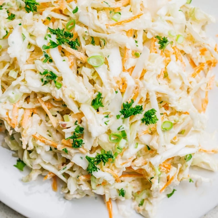 Vibrant Coleslaw with Apple featuring crunchy cabbage, sweet apple, and a light Greek yogurt dressing, garnished with fresh parsley.