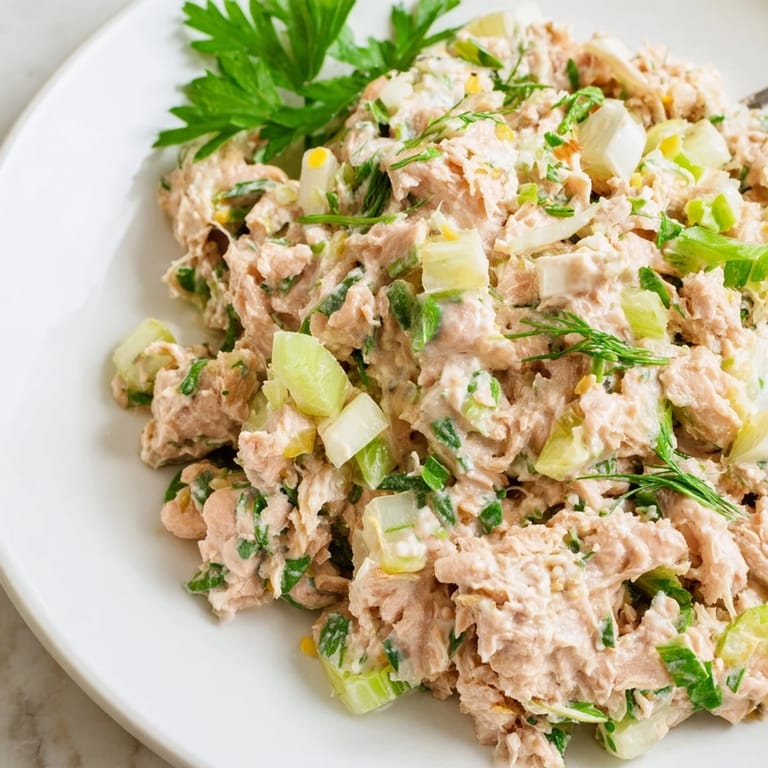 Bright, zesty Spicy Zesty Tuna Salad with crisp celery, tangy lemon, and a kick of hot sauce, ready to be scooped onto a sandwich.