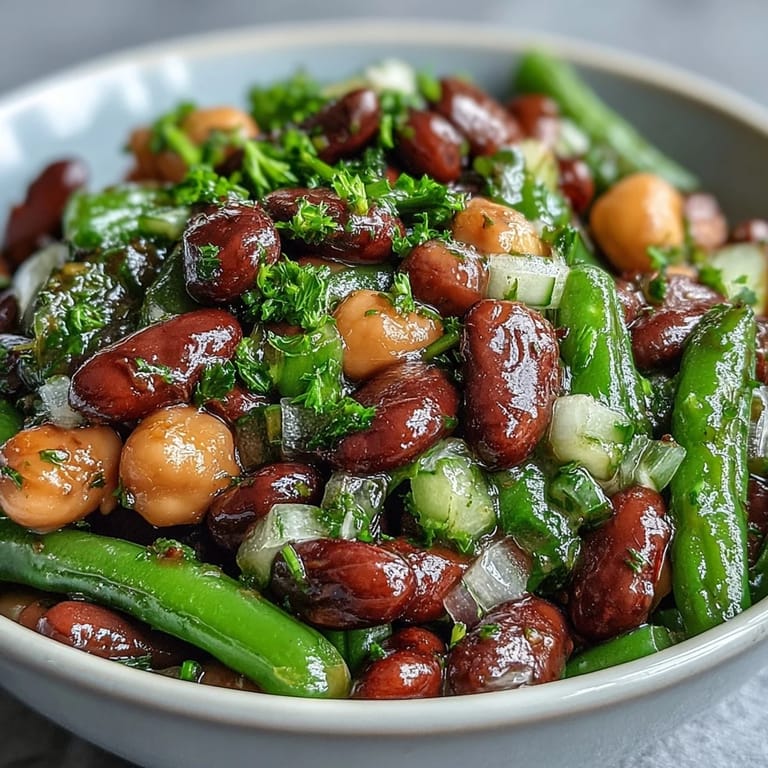 Delicious Three-Bean Salad, showcasing tender beans coated in a zesty dressing, perfect chilled.