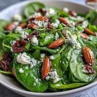 Spring Green Salad with Honey Mustard and Almonds: a vibrant mix of crisp greens, snap peas, and radishes topped with crunchy toasted almonds.