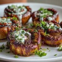 Golden-seared sea scallops bathed in rich lemon butter sauce, garnished with fresh parsley and lemon wedges.