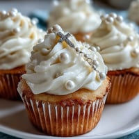 Delicate vanilla mini cupcakes topped with smooth buttercream and fondant rosary toppers, ideal for First Communion celebrations.