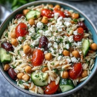 Mediterranean Orzo with Chickpeas, a colorful vegetarian bowl with vibrant veggies and herbs.
